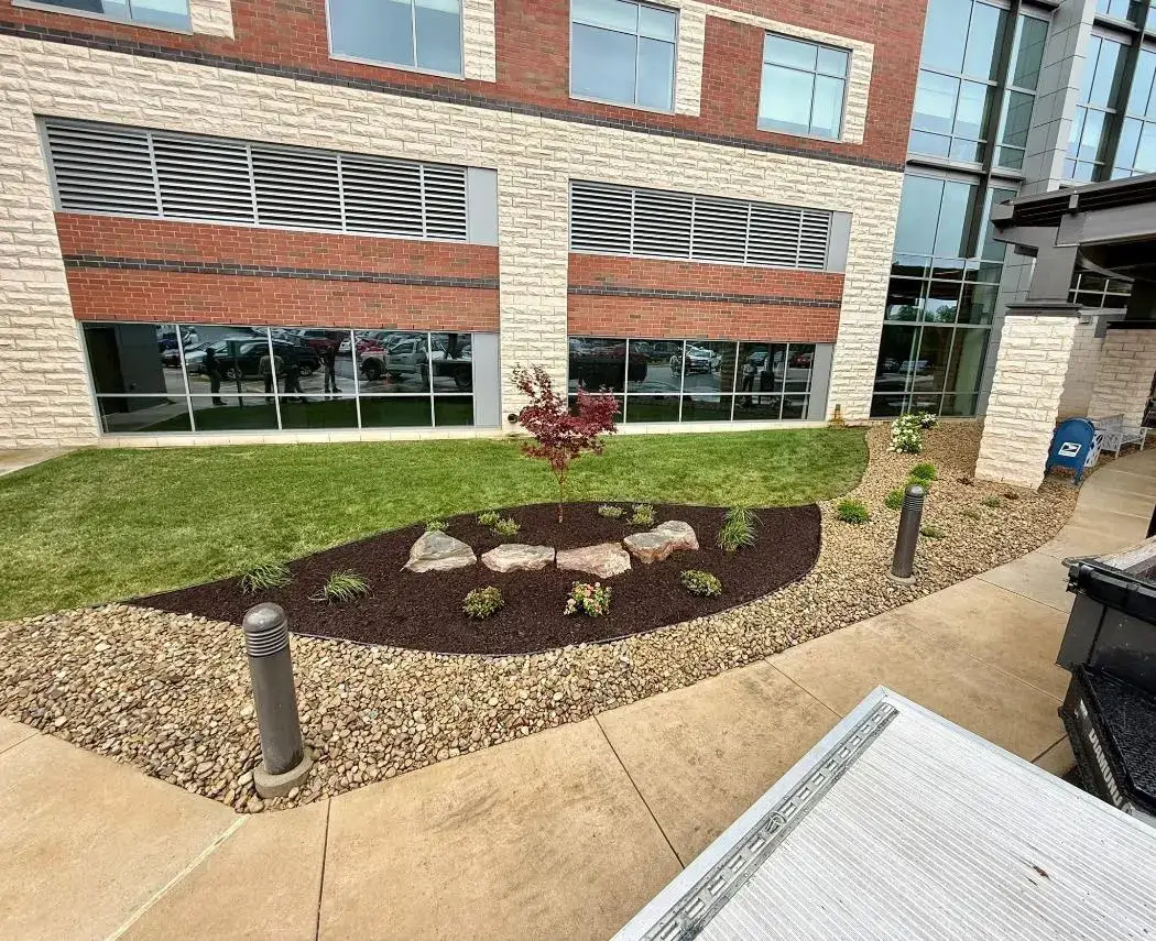 Landscape bed with mulch and stone at the entrance of a commercial building