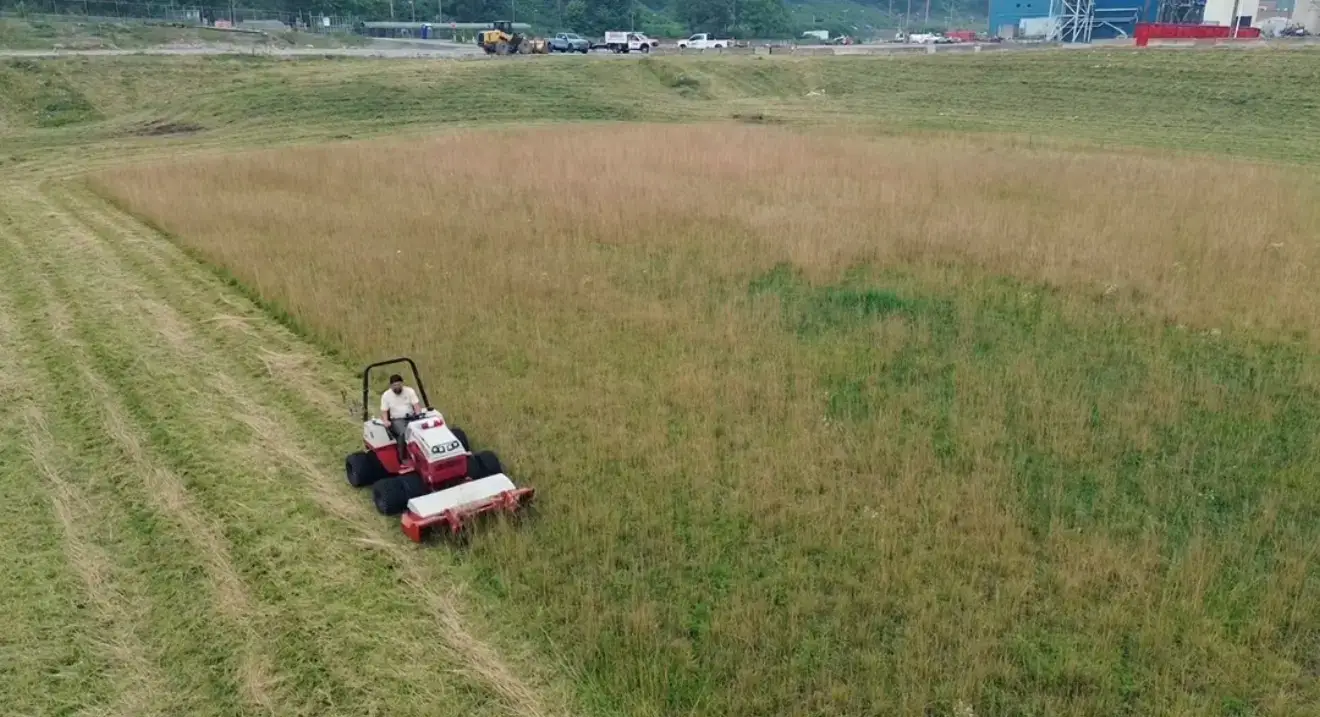 Mower cutting a large grass area